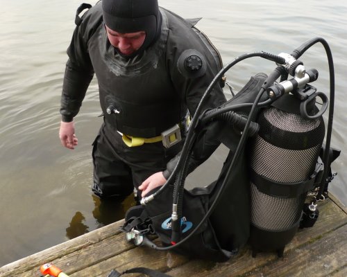 Police diver exiting the water at a jetty